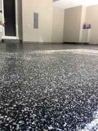 A close up of a black and white floor in a garage.