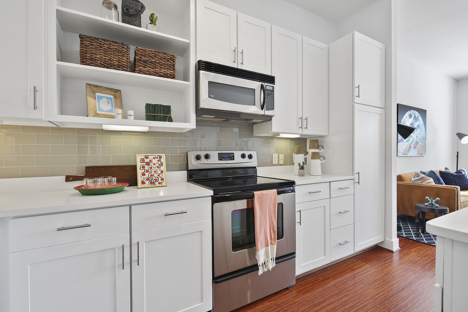 A kitchen with white cabinets and stainless steel appliances.