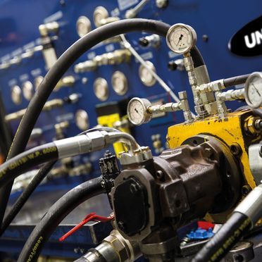 A bunch of hydraulic hoses are connected to a machine