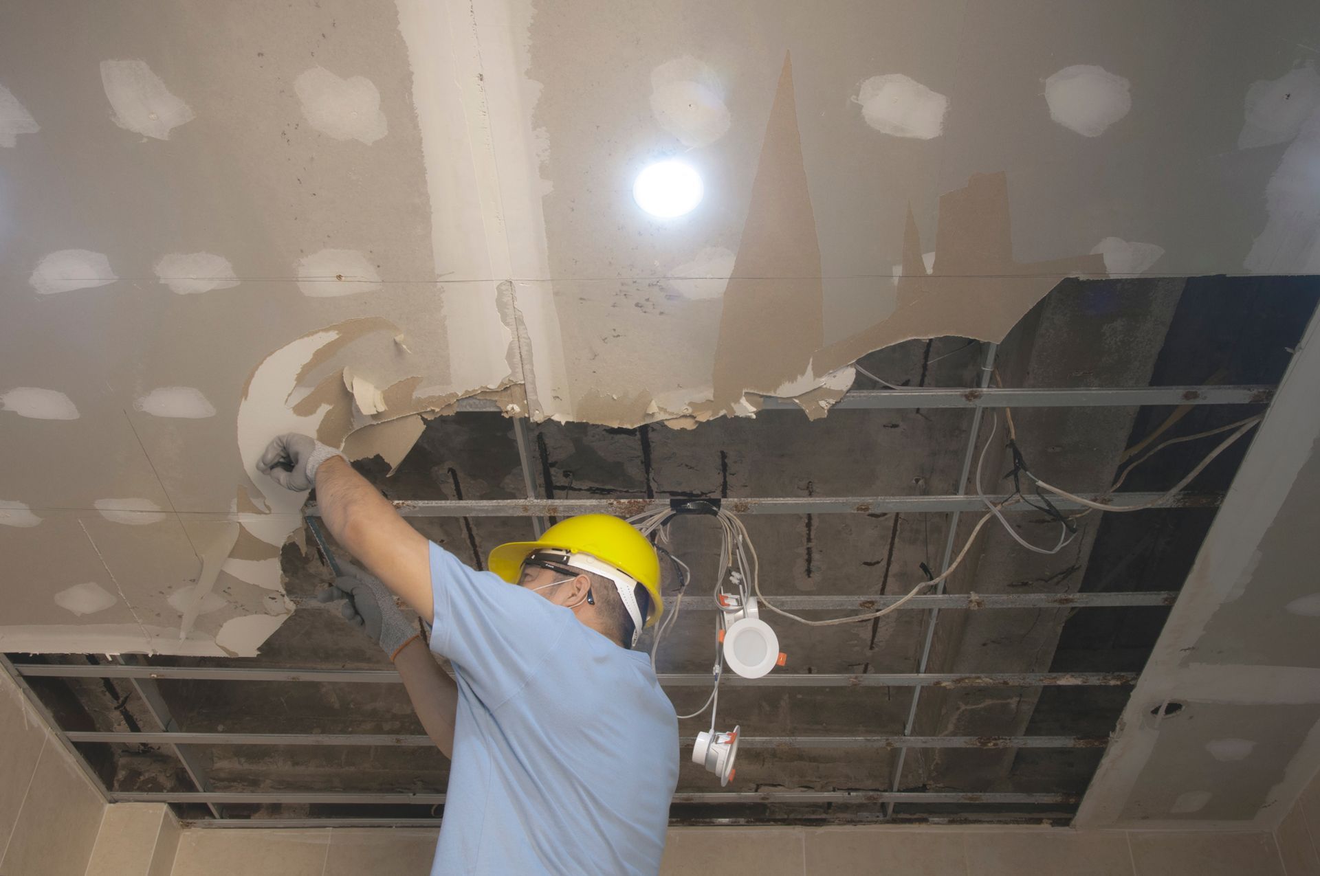 A Man Fix Ceiling From Water Leak