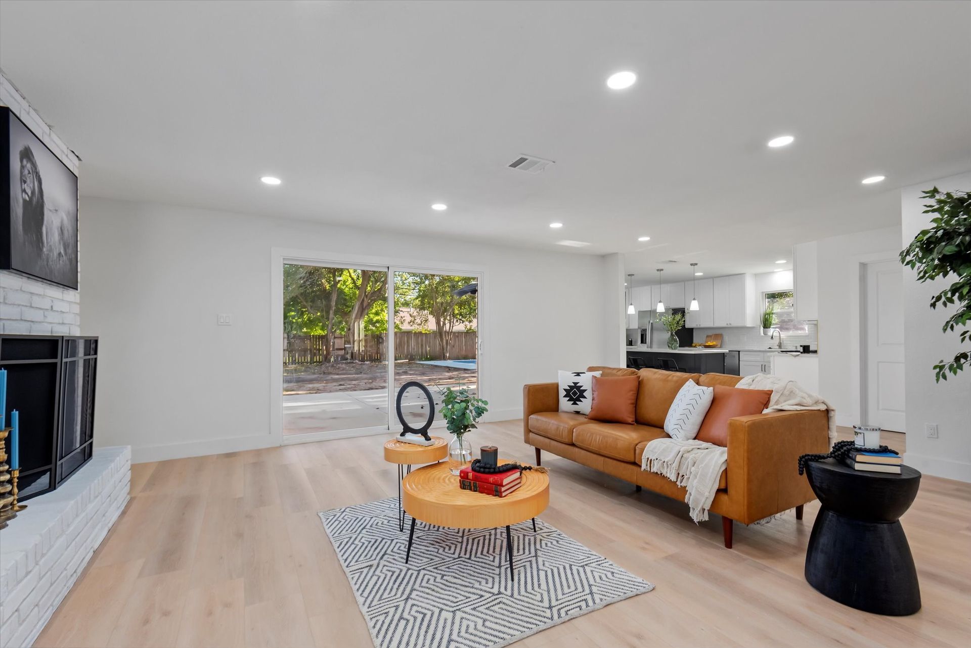 A living room with a couch , coffee table , and fireplace.