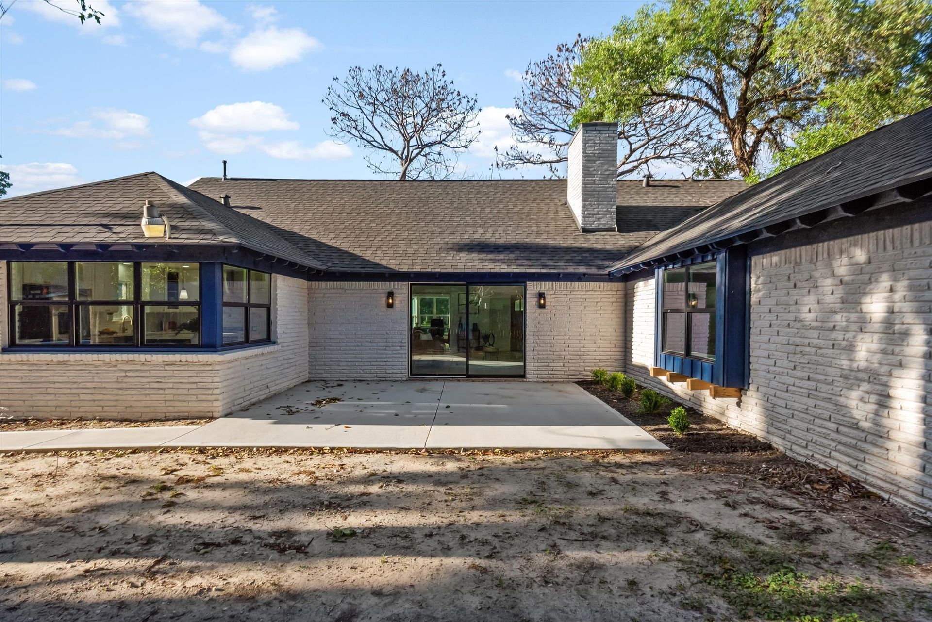 The back of a house with a large sliding glass door.