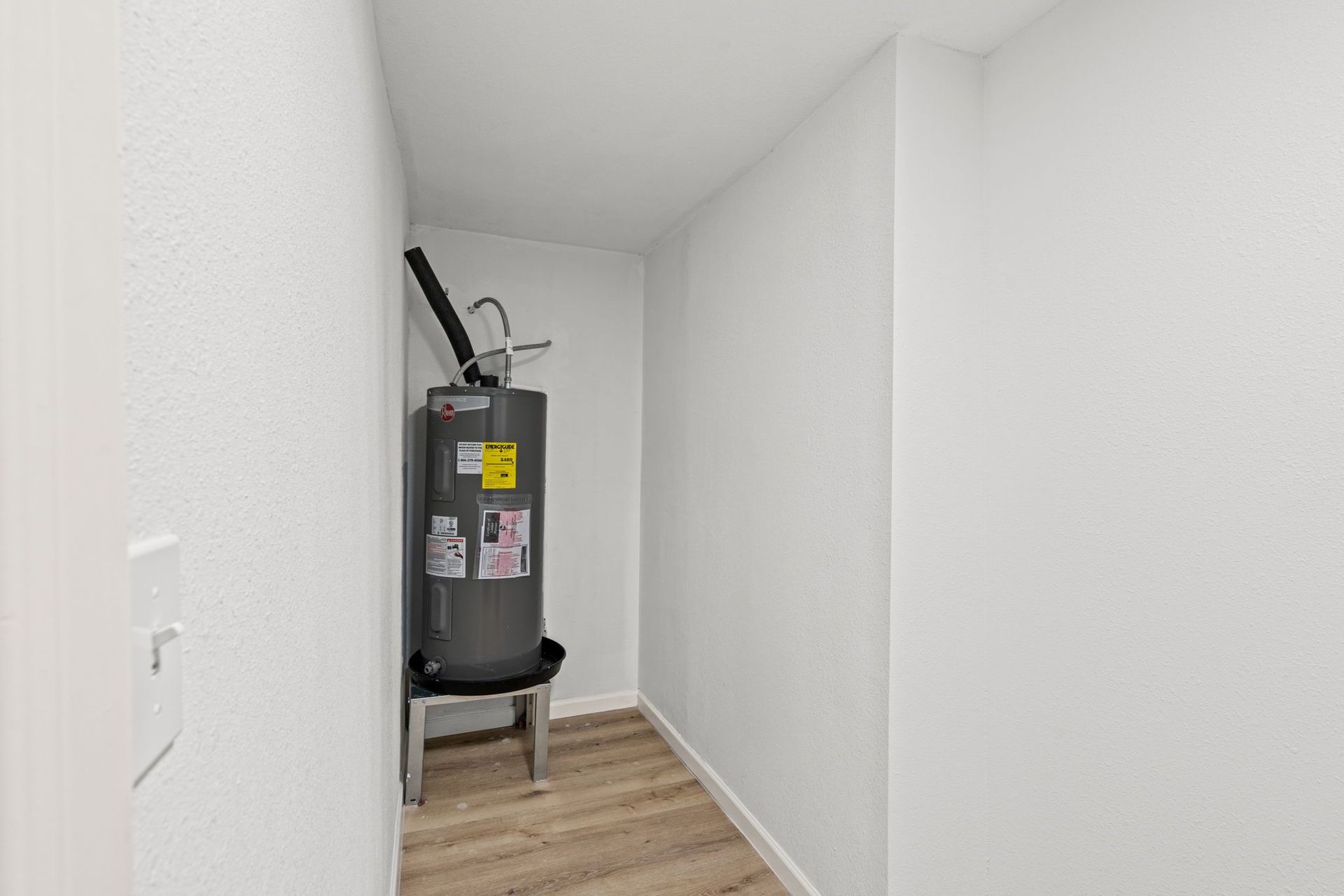 There is a water heater in the corner of the room.