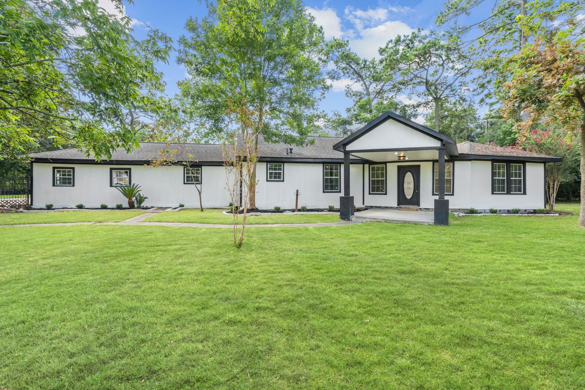 A large white house with a large lawn in front of it.