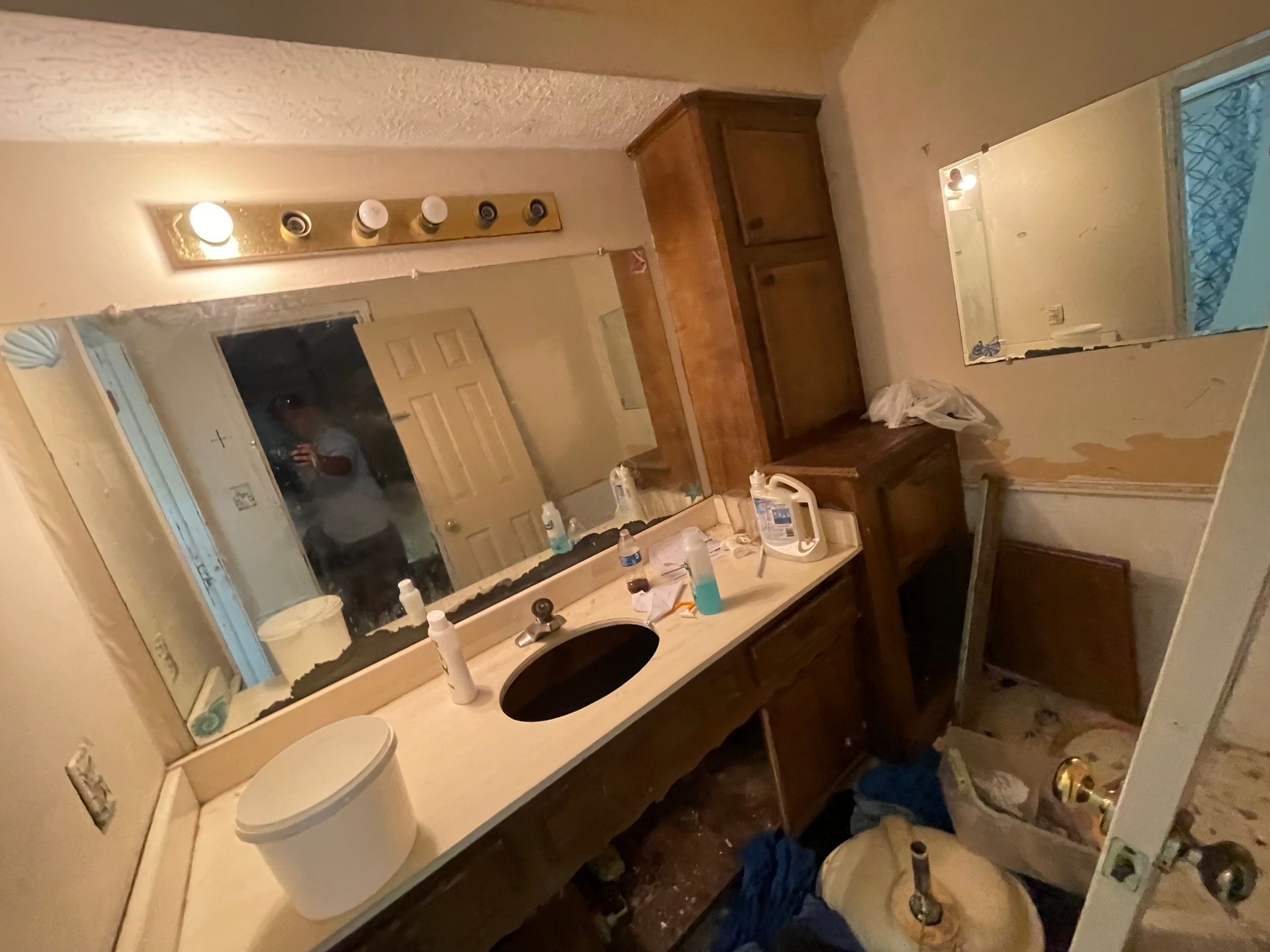 A bathroom with a sink , toilet and mirror.