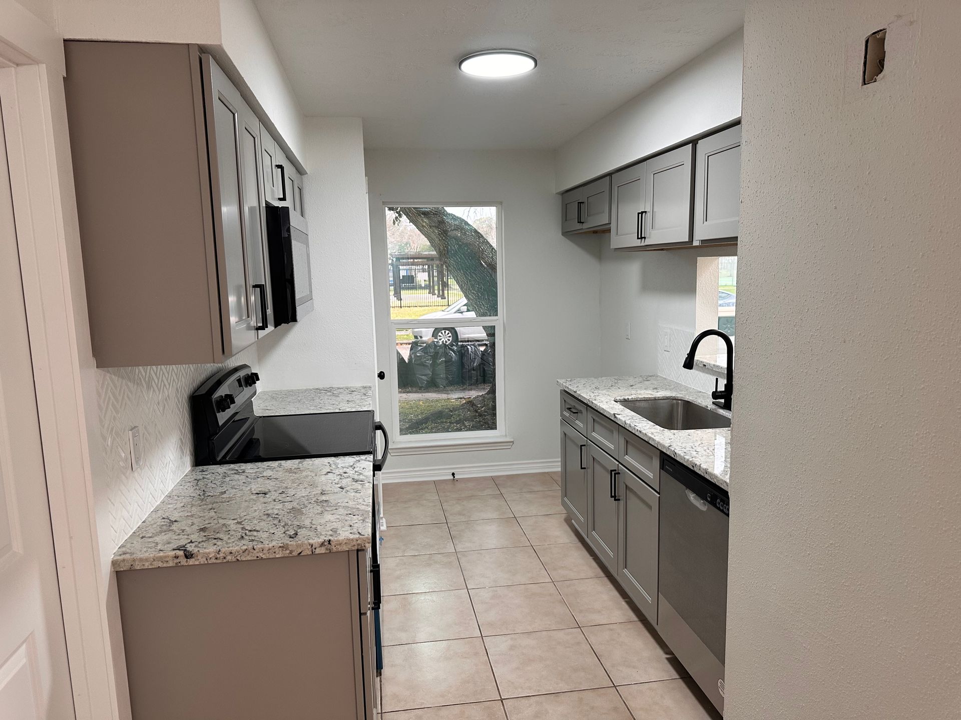 A kitchen with stainless steel appliances and granite counter tops