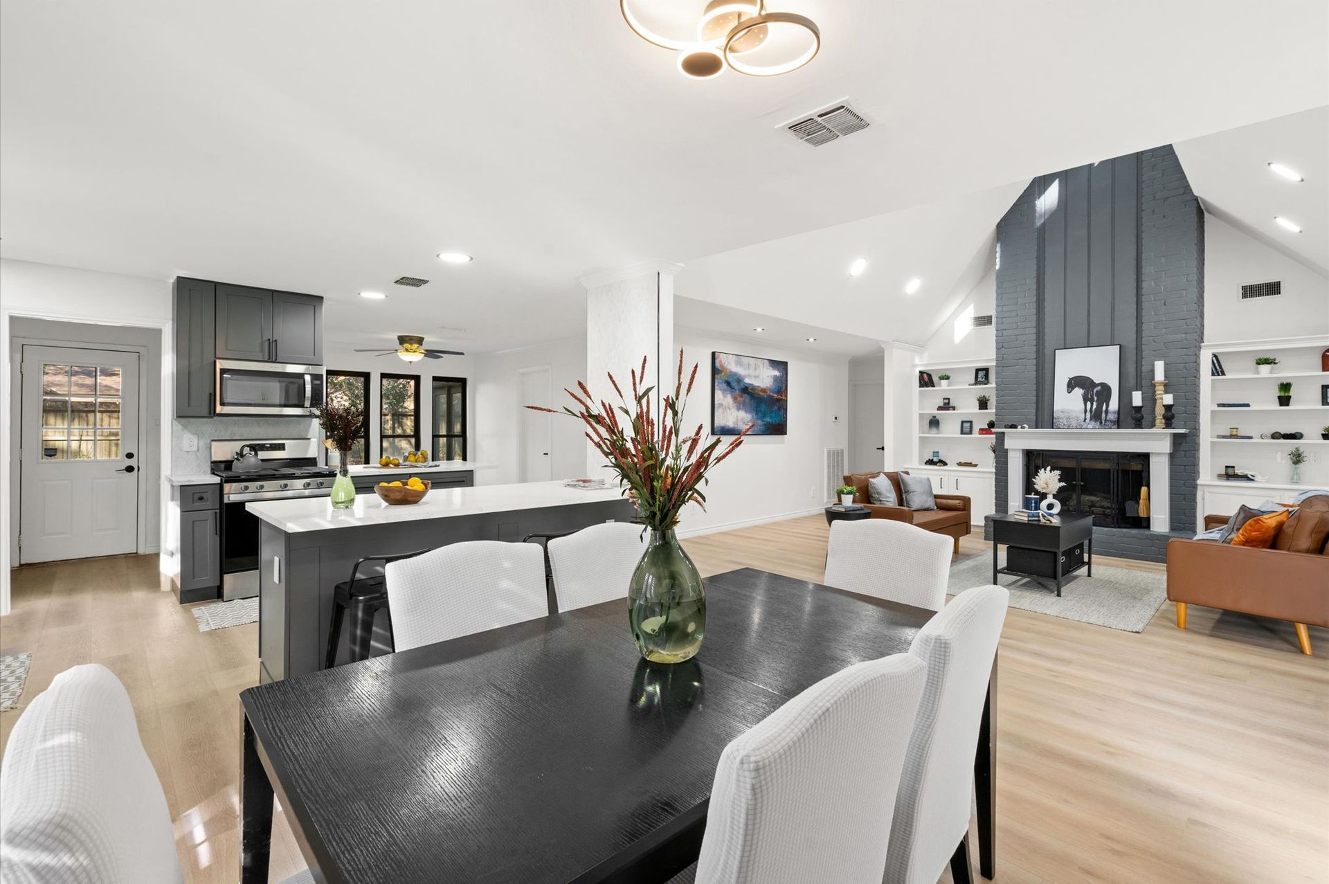 There is a dining table and chairs in the middle of the room.