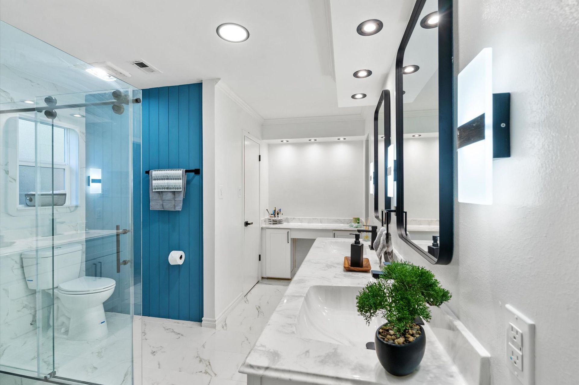 A bathroom with a sink , toilet , and shower.