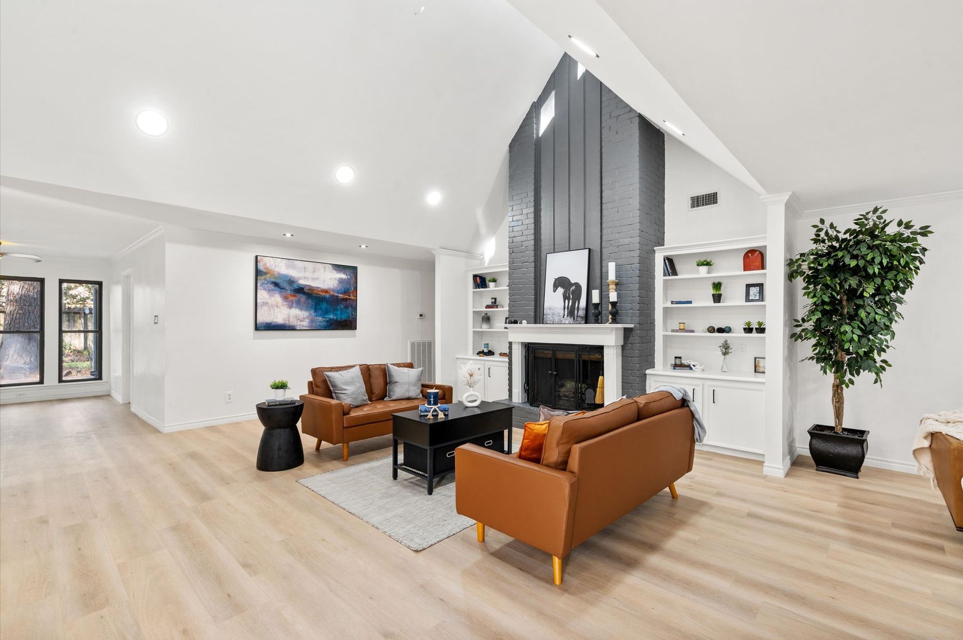 A living room filled with furniture and a fireplace.