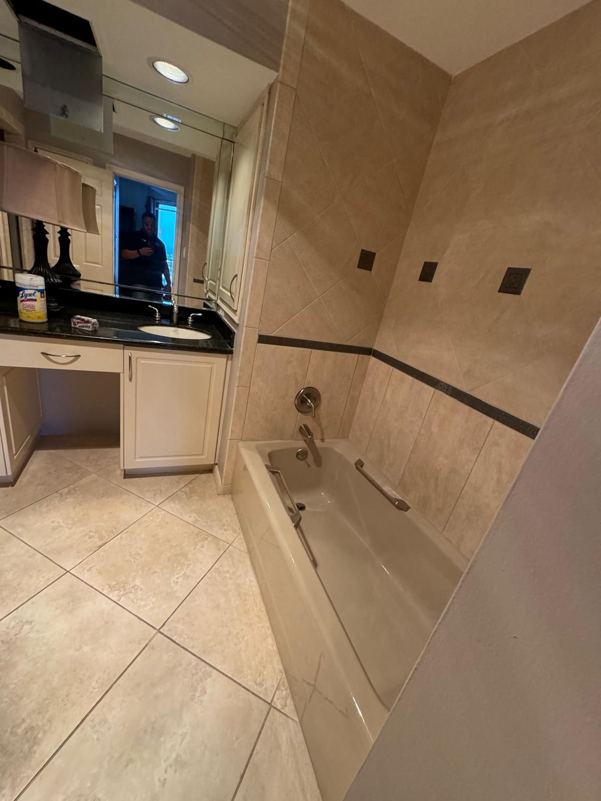 A old bathroom with a tub , sink and mirror