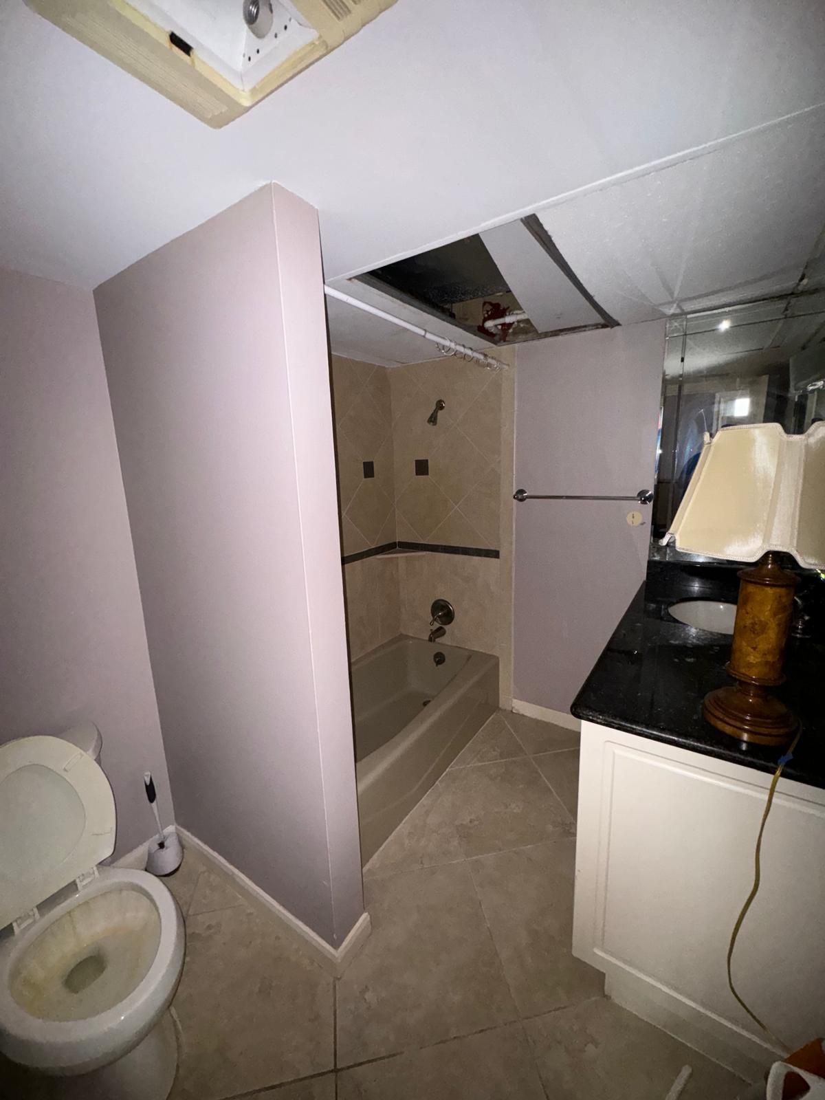 A old bathroom with a toilet , sink and bathtub