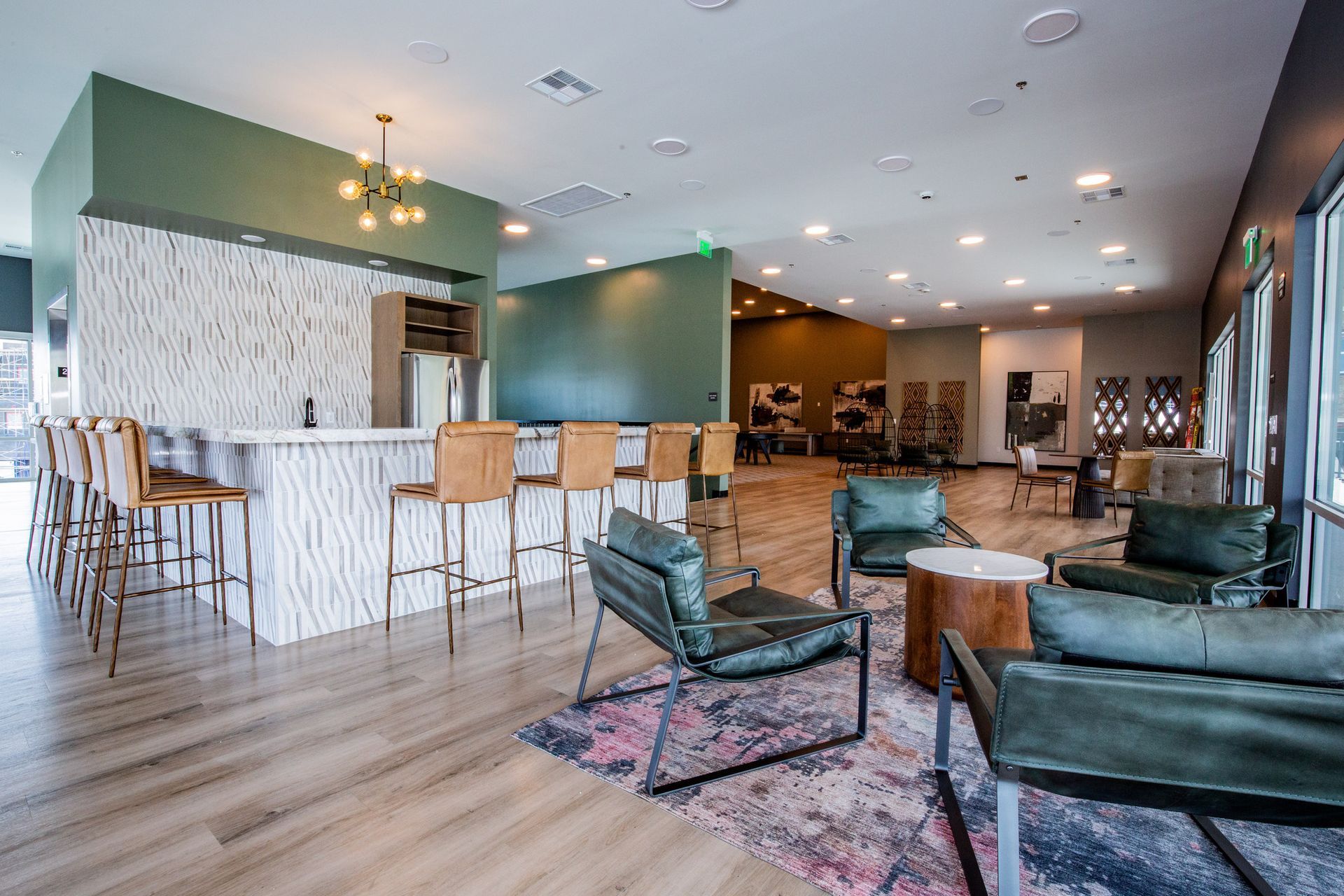 A large room with a lot of furniture and a bar.