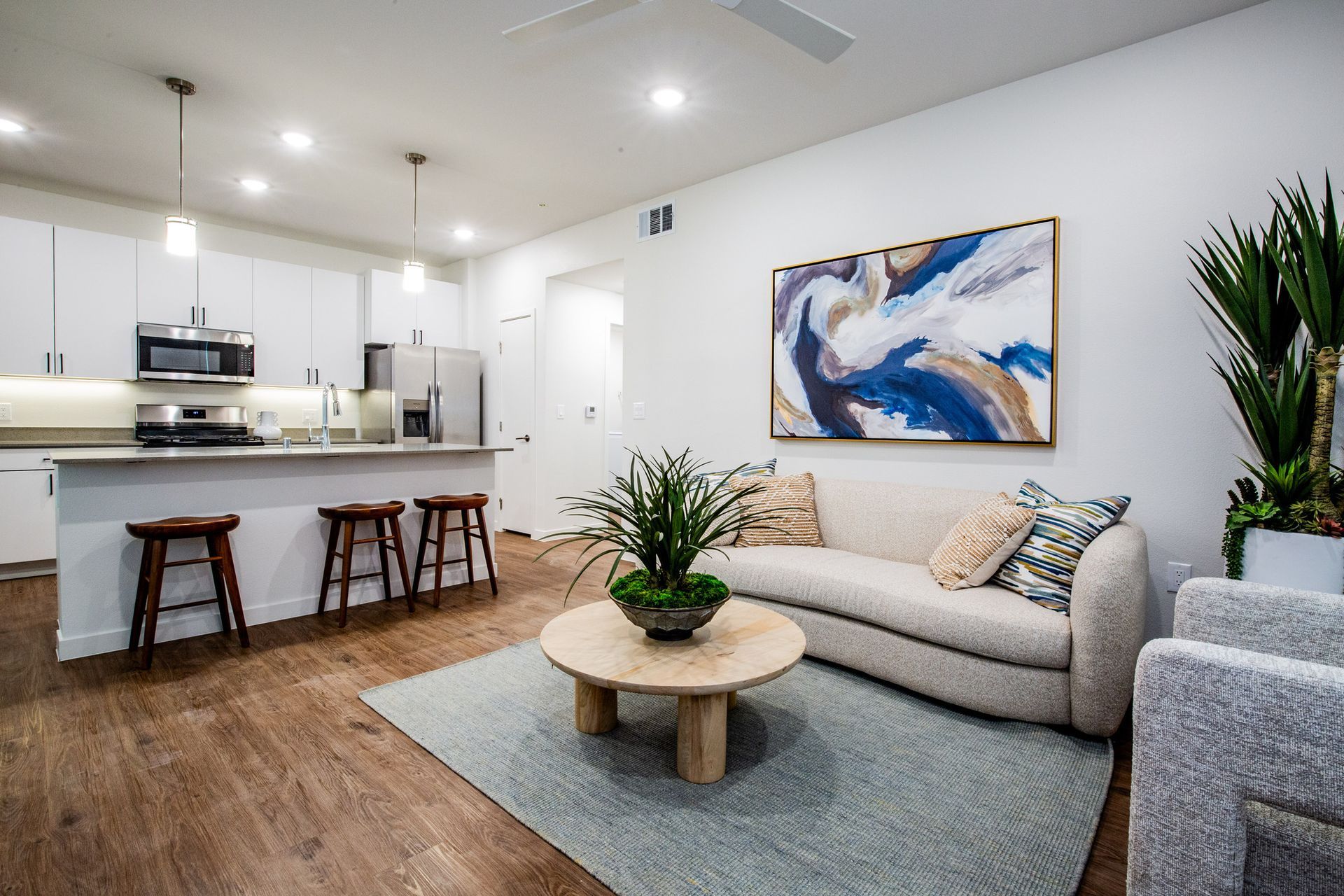 A kitchen with a large island and stainless steel appliances.