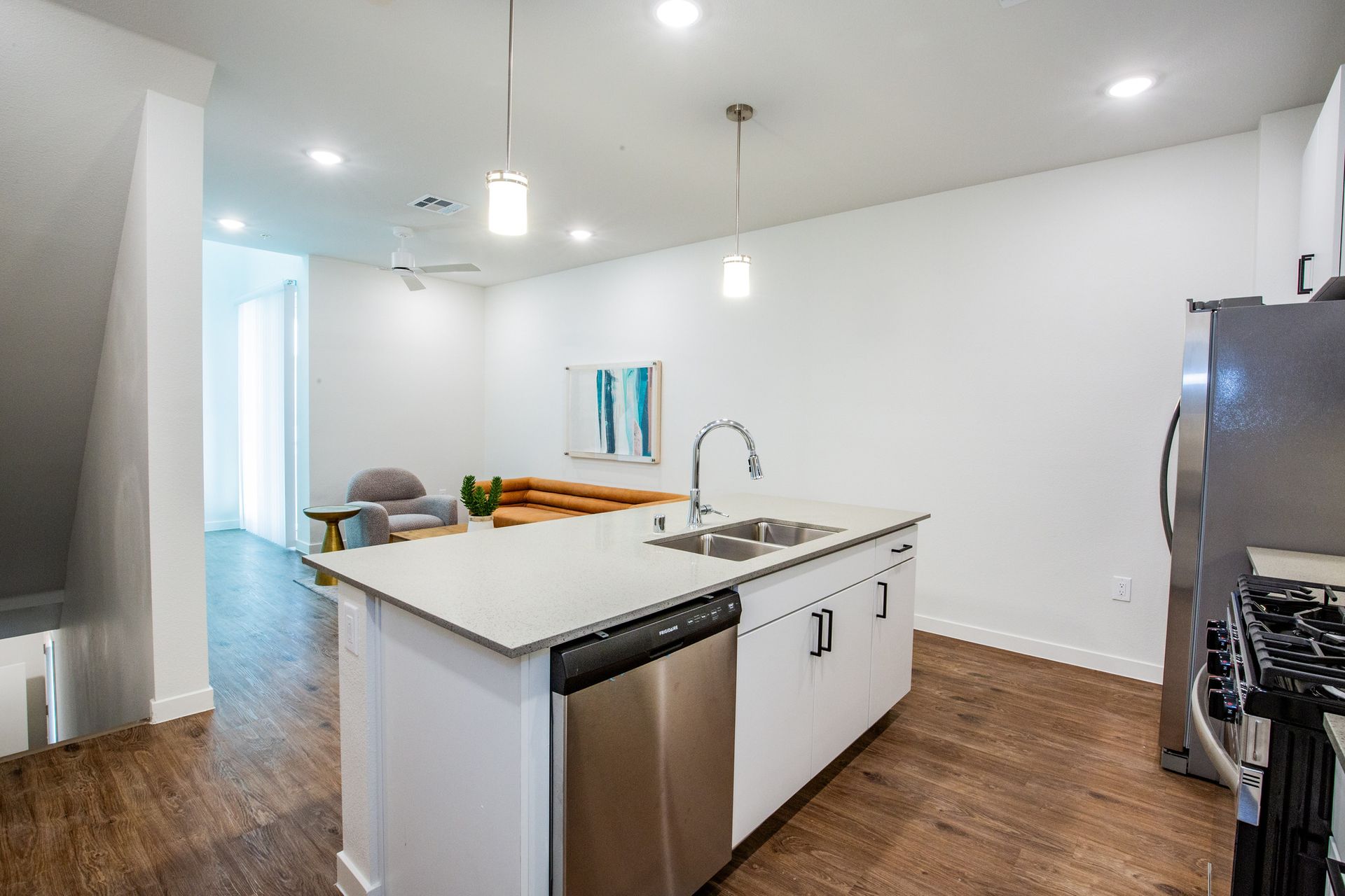 A kitchen with a large island and stainless steel appliances.