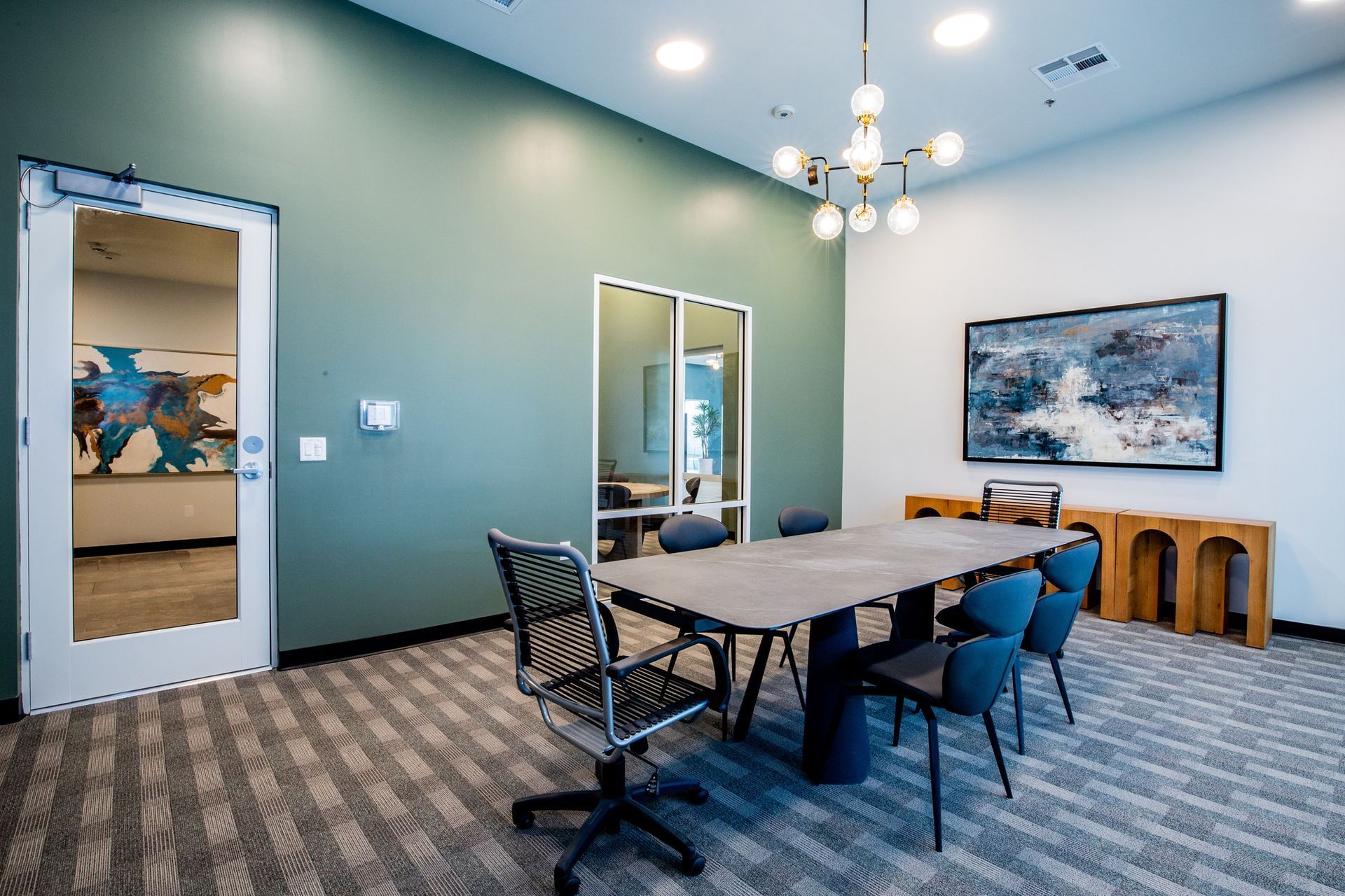 A conference room with a table and chairs in it.