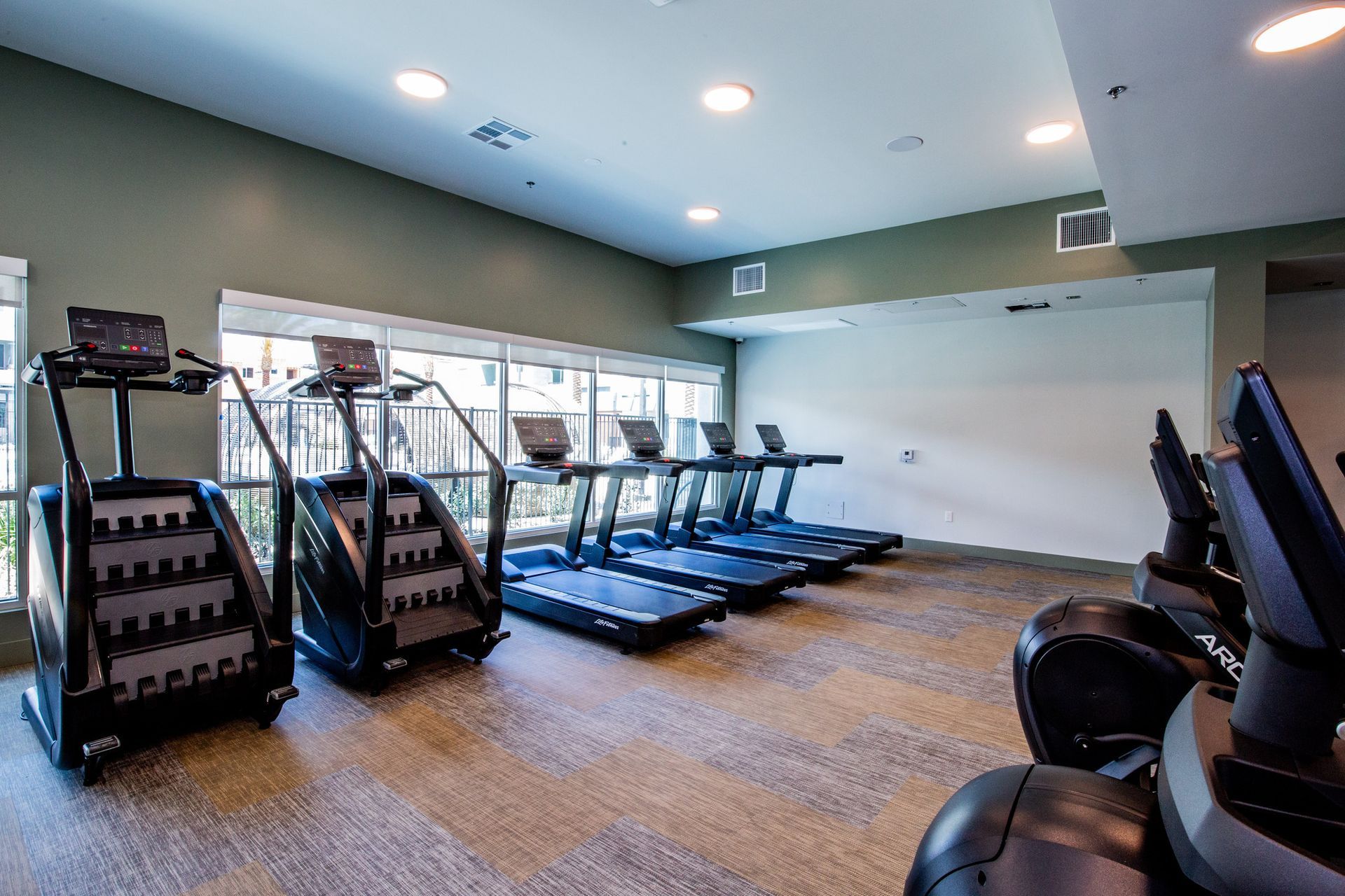 A gym with a lot of treadmills and exercise bikes.