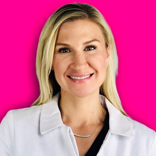 A blonde person in a white collared jacket smiling against a bright pink background.