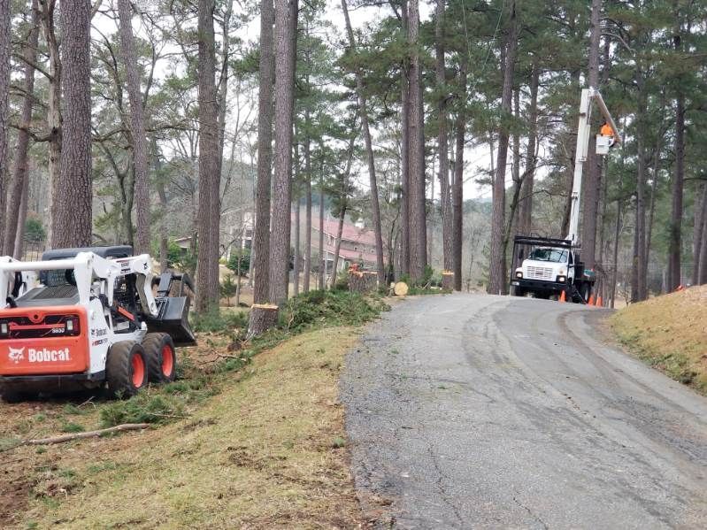 A bobcat tractor is parked on the side of a road.
