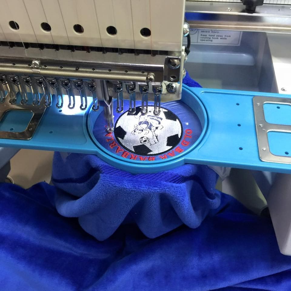 A Soccer Ball is Being Embroidered on a Blue Shirt — Fab Art in Forster, NSW