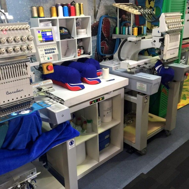 A Row of Embroidery Machines Are Lined Up in a Room — Fab Art in Forster, NSW