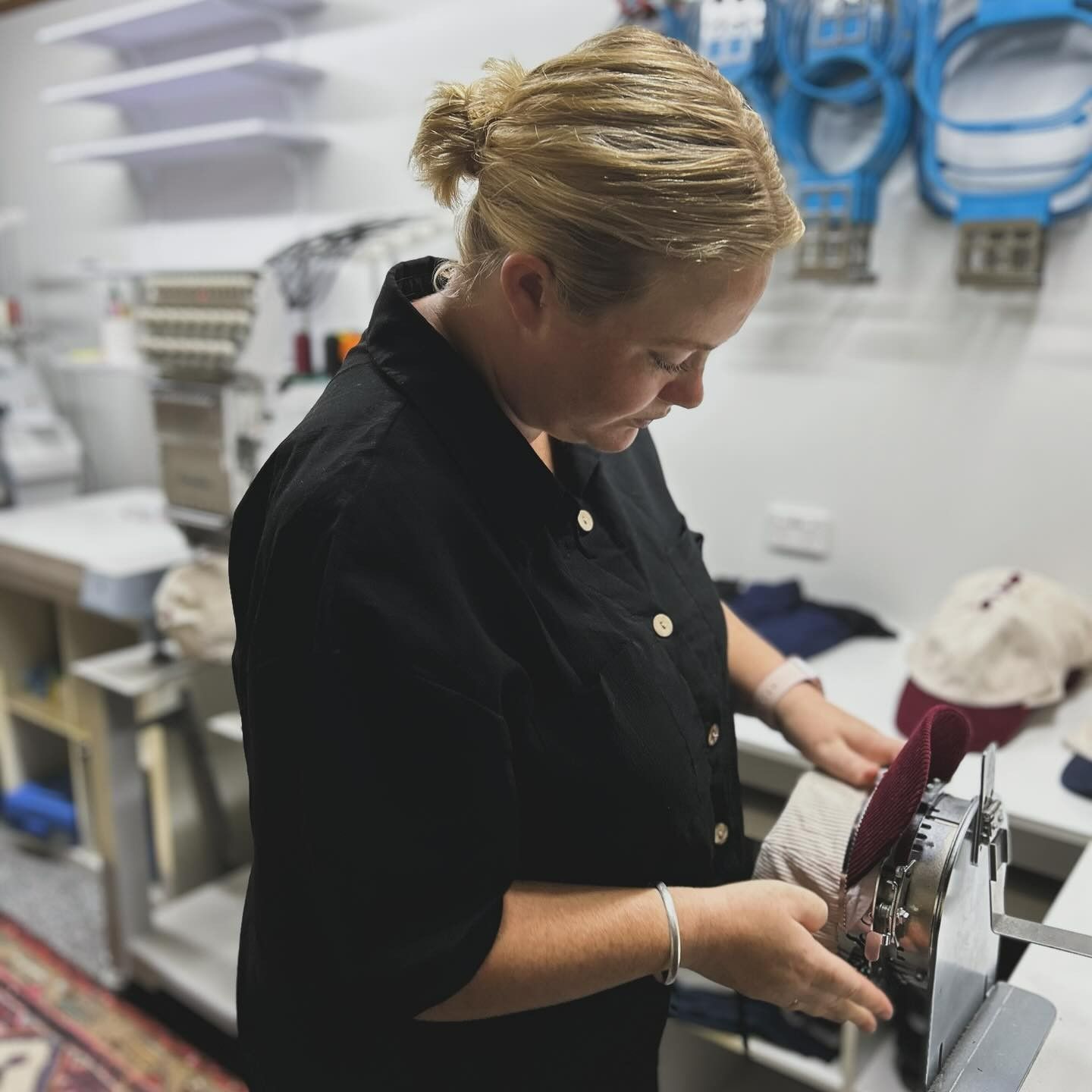 A Woman in a Black Shirt is Working on a Machine — Fab Art in Wallabi Point, NSW