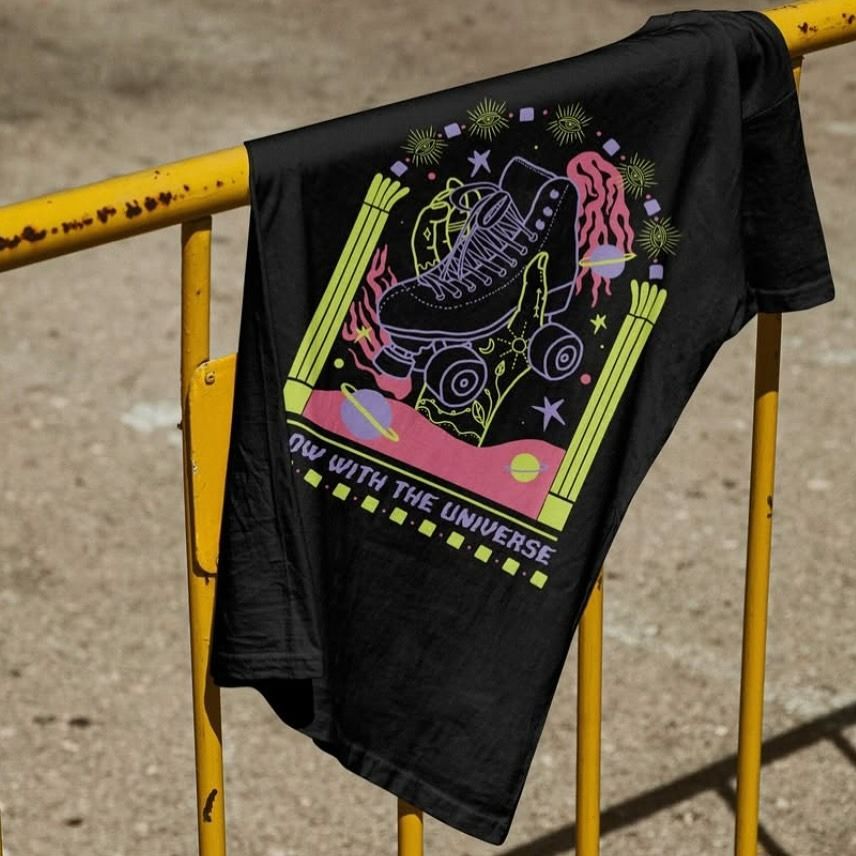 A Black T-Shirt with Roller Skates on It Is Hanging on A Yellow Railing — Fab Art in Port Macquarie, NSW