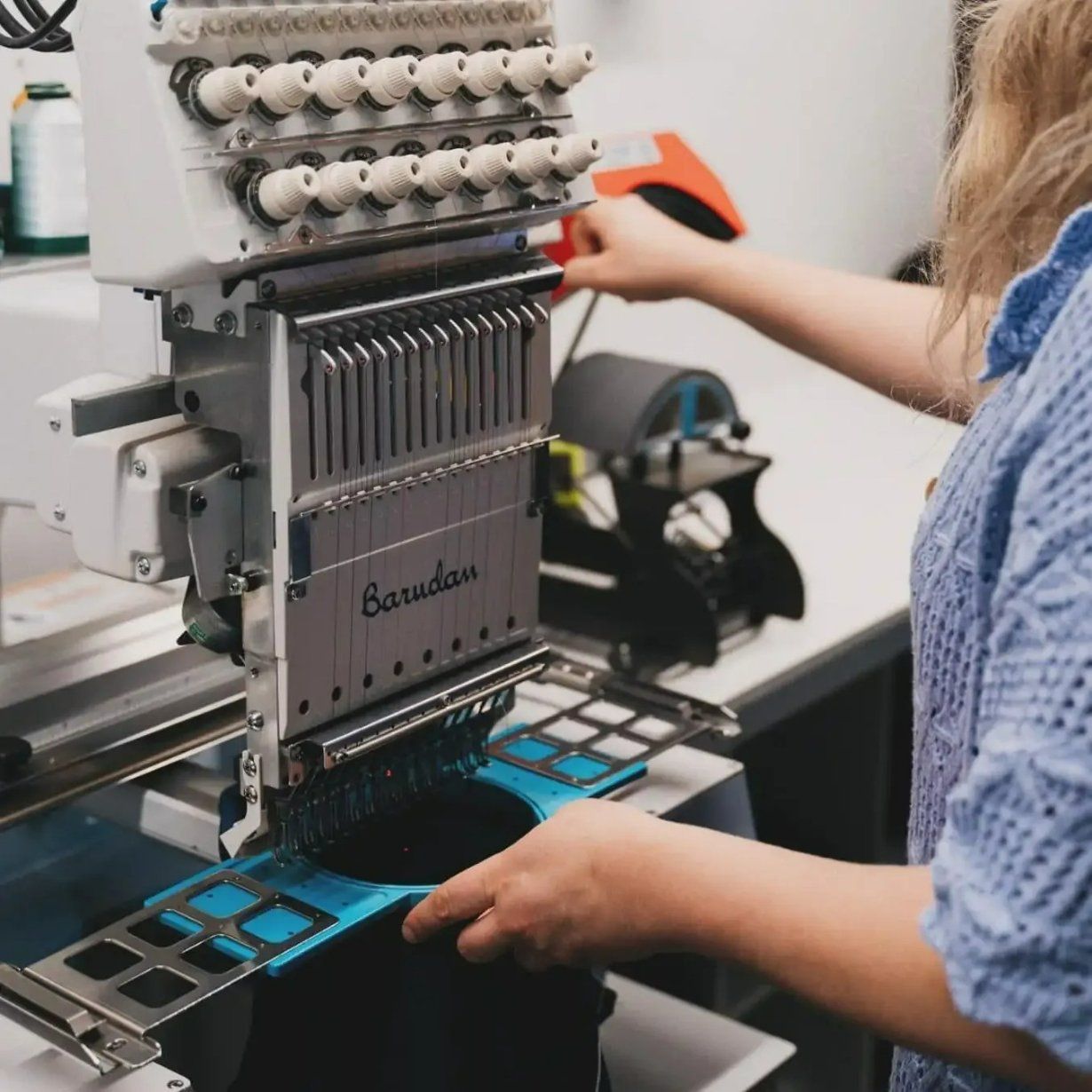 A Woman Is Working on A Machine — Fab Art in Port Macquarie, NSW