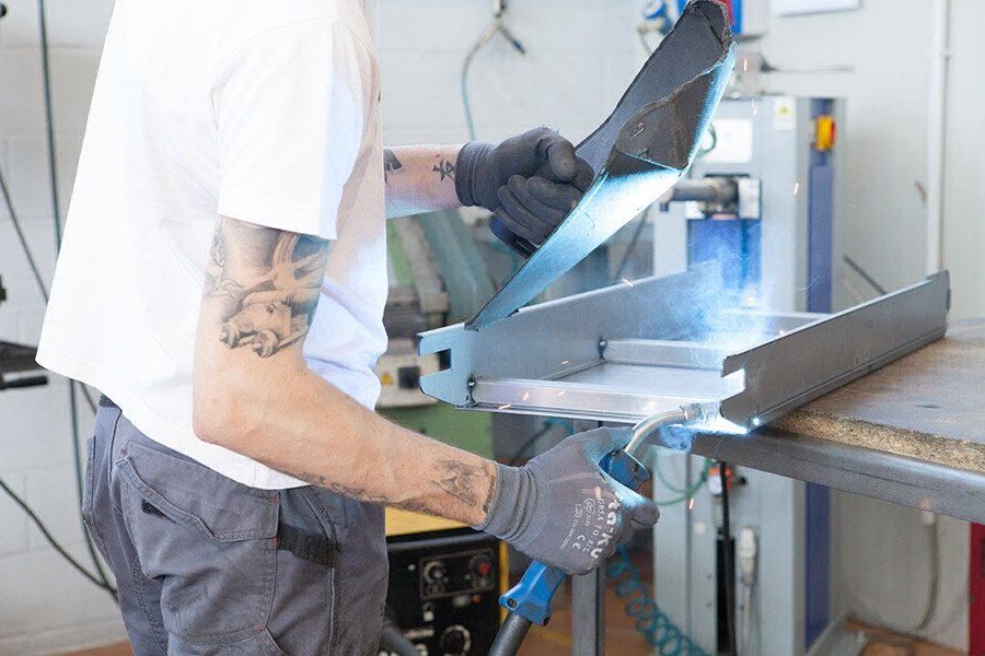 Operator welds some metal components