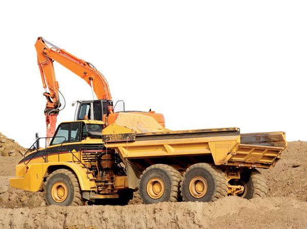 A yellow dump truck with a crane on top of it.