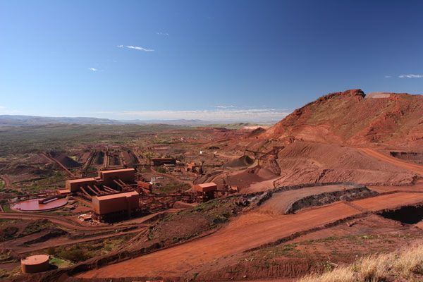 A view of a mine from the top of a hill on a sunny day.