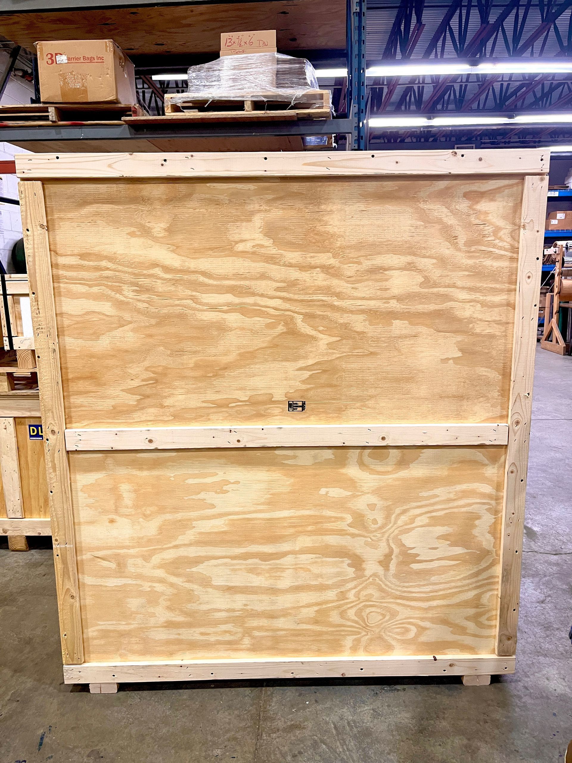 The fully-constructed crate, containing the sign, which is no longer visible in the image because the front of the crate has been screwed on to complete it.