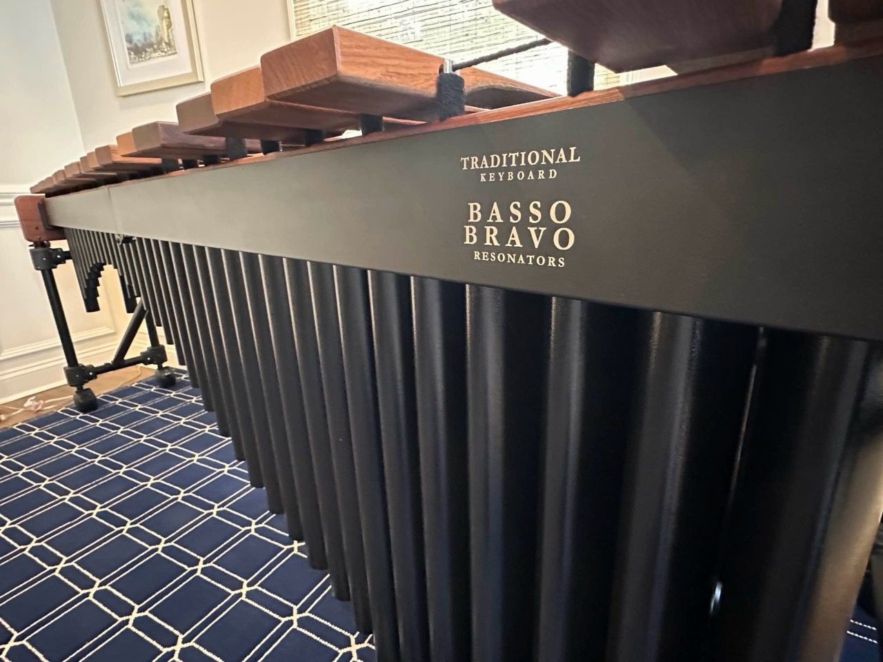 The marimba that Commerce Packaging packaged, inside a building. The image focuses on the marimba's resonators, rail (which says 
