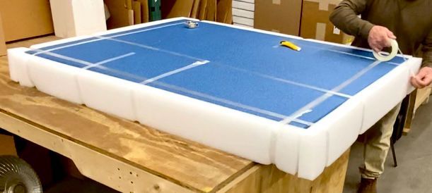 The 2” polyethylene foam from the previous image, now used to box up the painting from a previous image (which is still wrapped in wrapping paper)