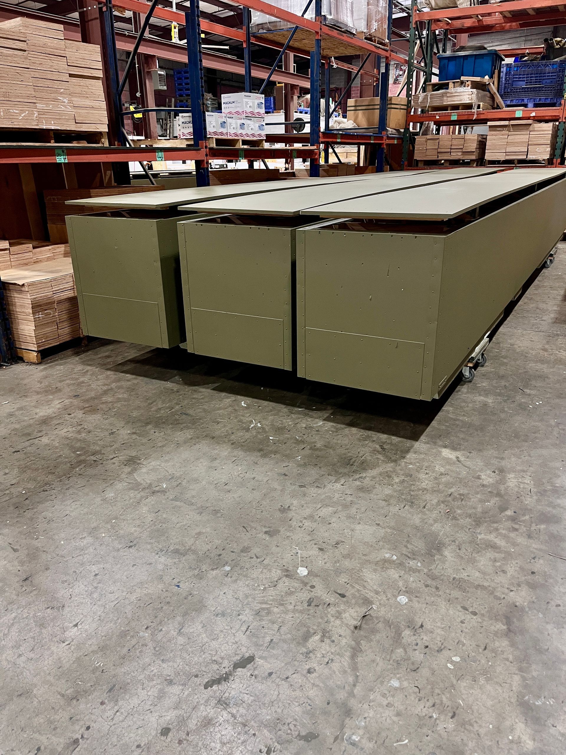 Crates painted green inside Commerce Packaging's facility