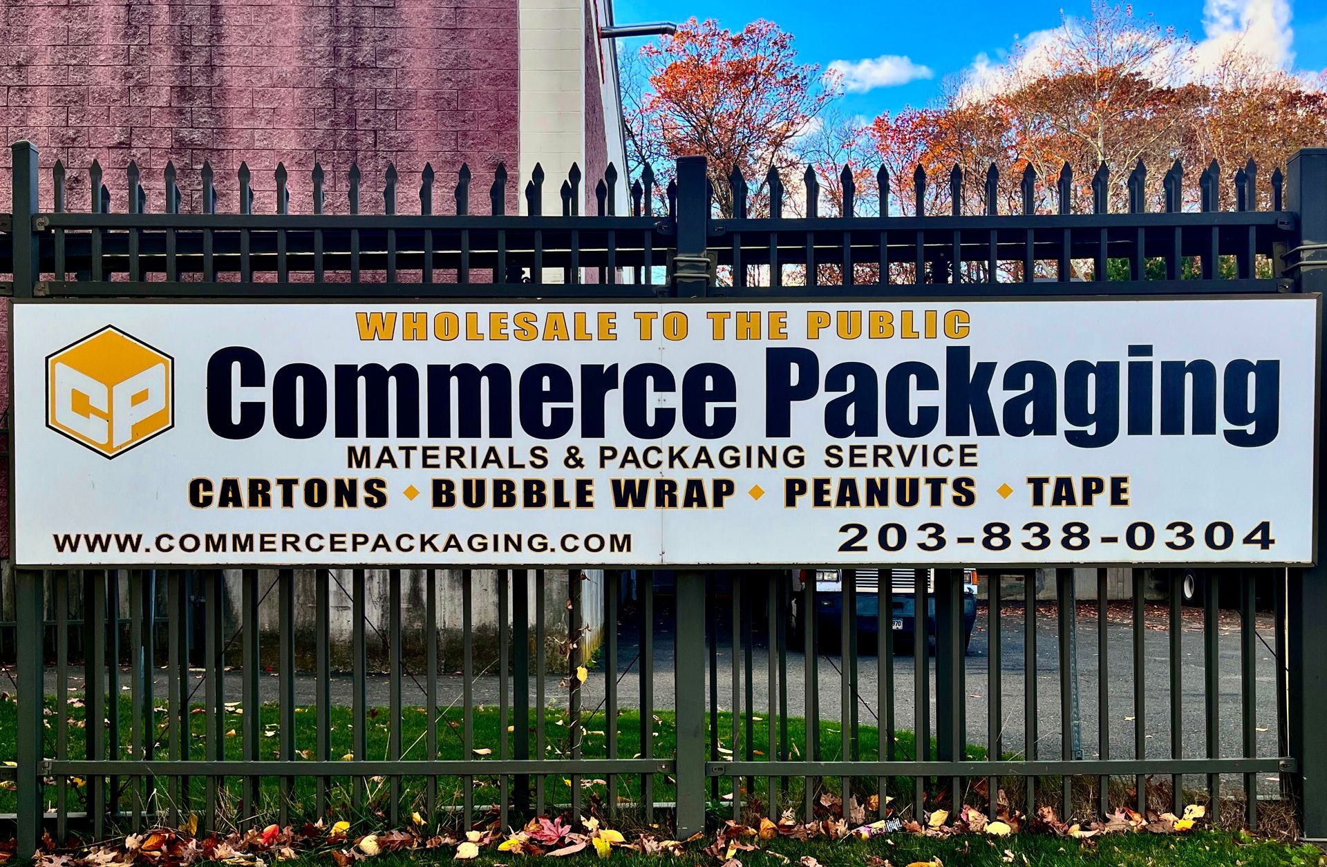 A sign on a gate on the exterior of Commerce Packaging's facilities. The sign reads 