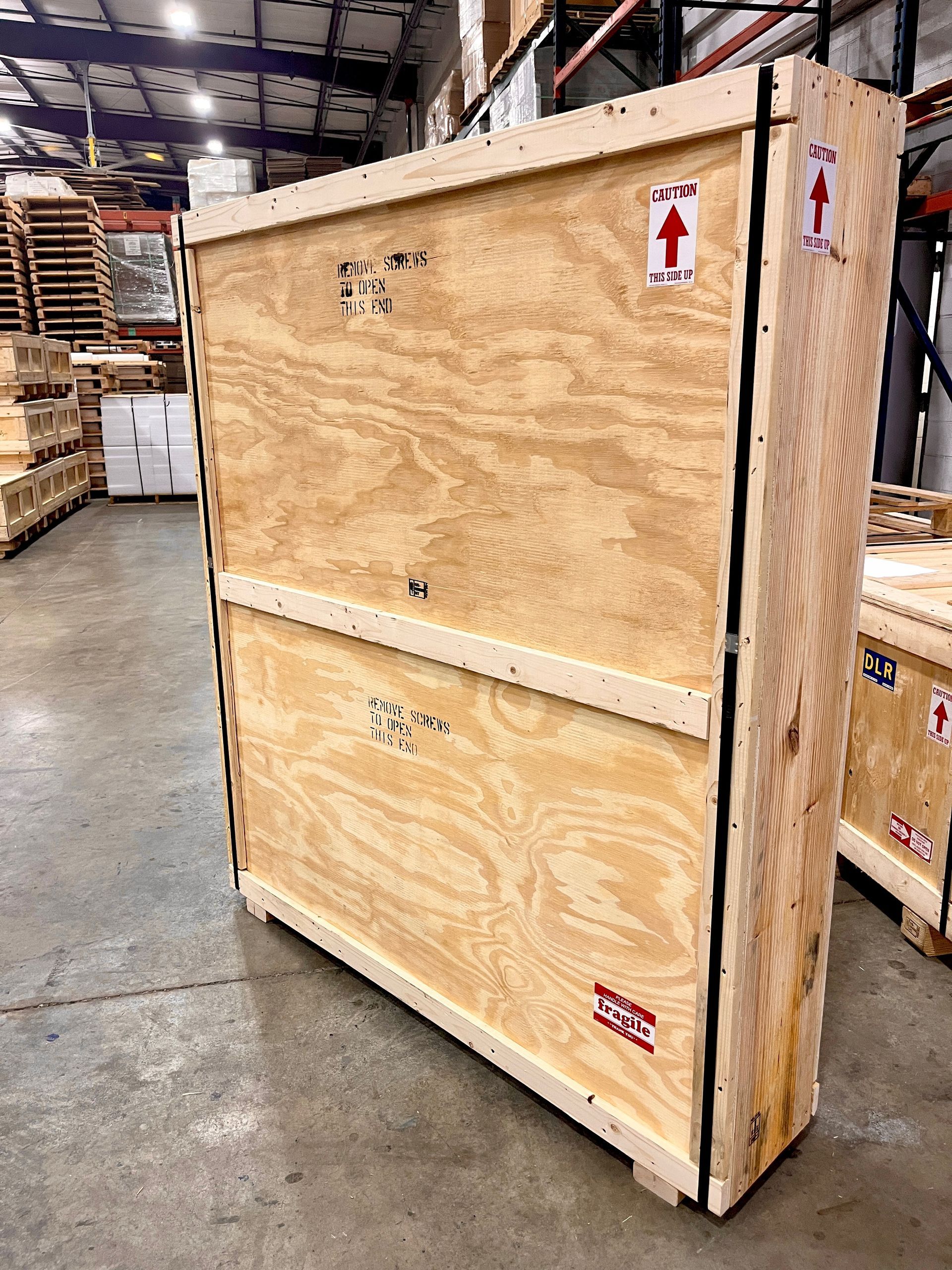 The fully-finished product. The crate has its front, and now straps, informational stickers, and stencils have been added.