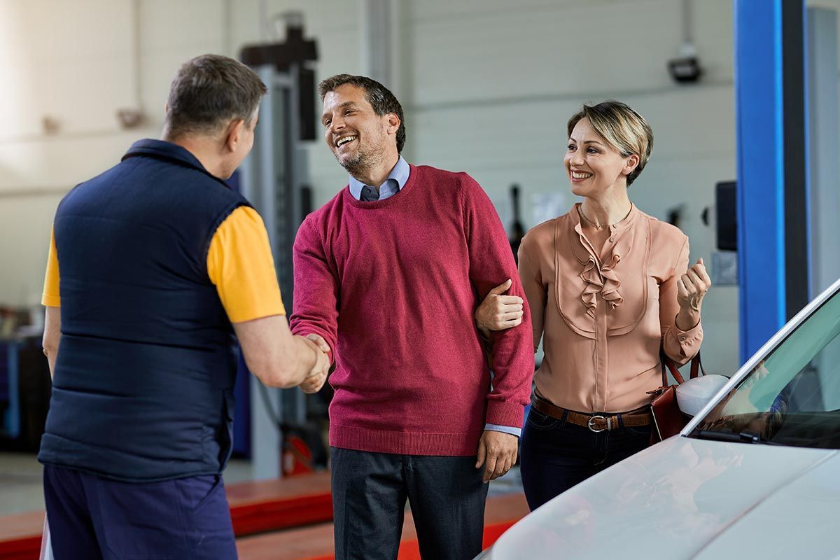 Orange McLaren sports car parked on dark textured surface.