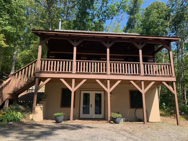 A Small House With A Large Porch And Stairs In The Woods – Boone, NC – A Brush Above Painting