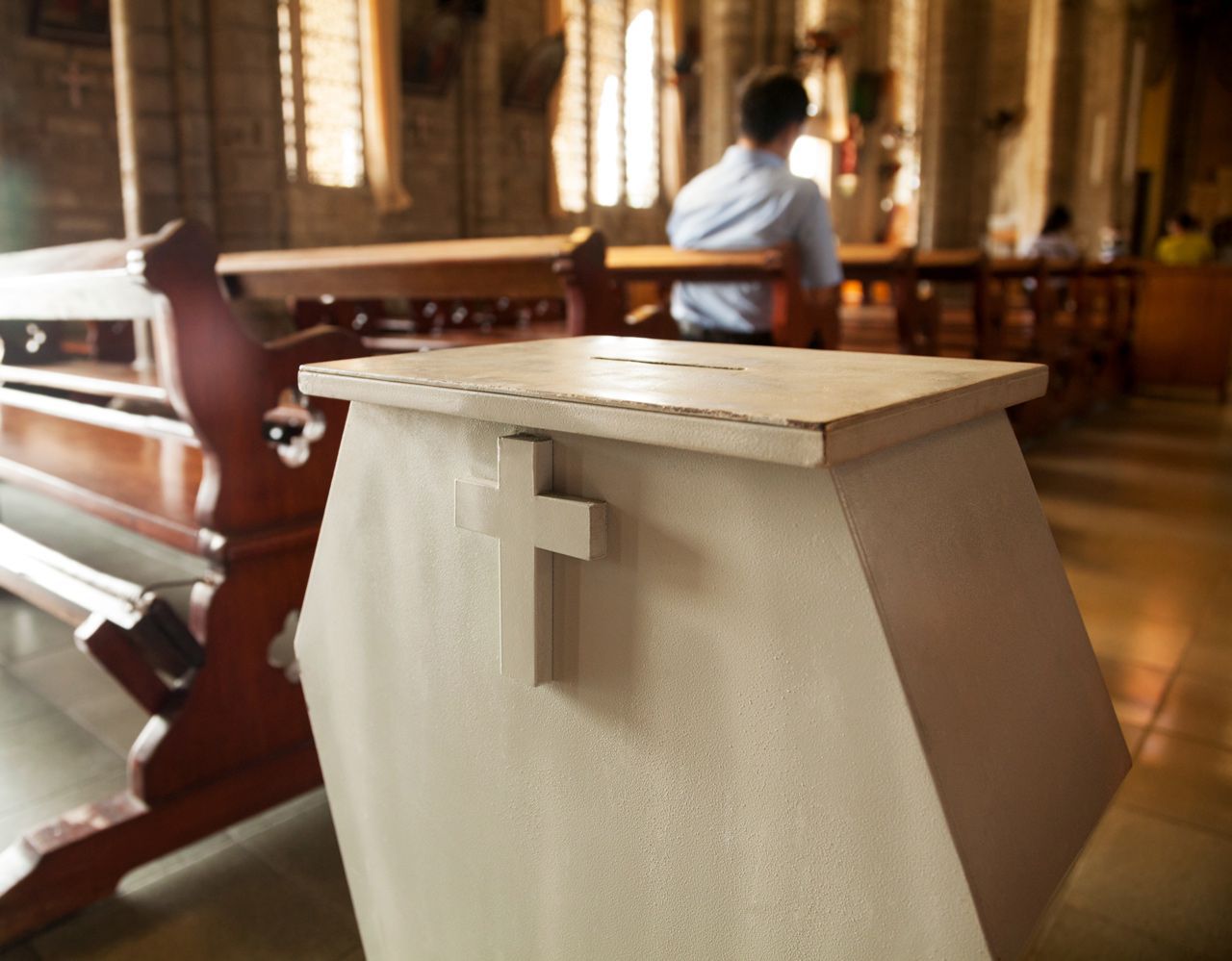A white box with a cross on it in a church