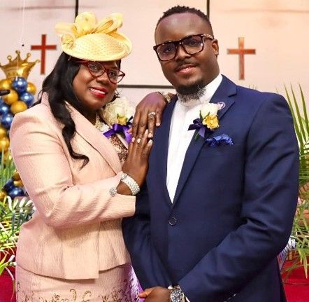 A row of small houses with red trim are lined up in a parking lot.