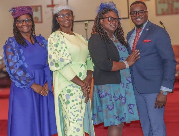 A group of people are posing for a picture in a church.