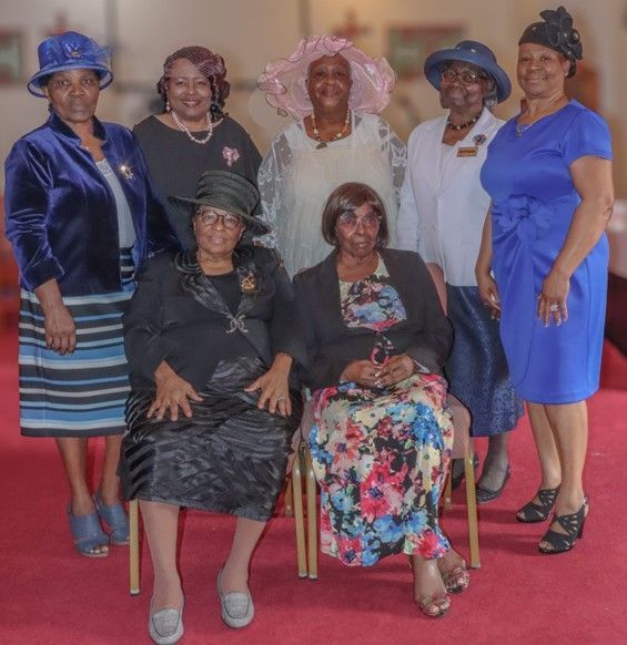 A group of women are posing for a picture together