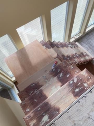 A professional handyman is installing a sturdy staircase in a residential home.