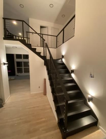 An elegant staircase with sleek wooden steps expertly installed to enhance the aesthetic appeal of the space.