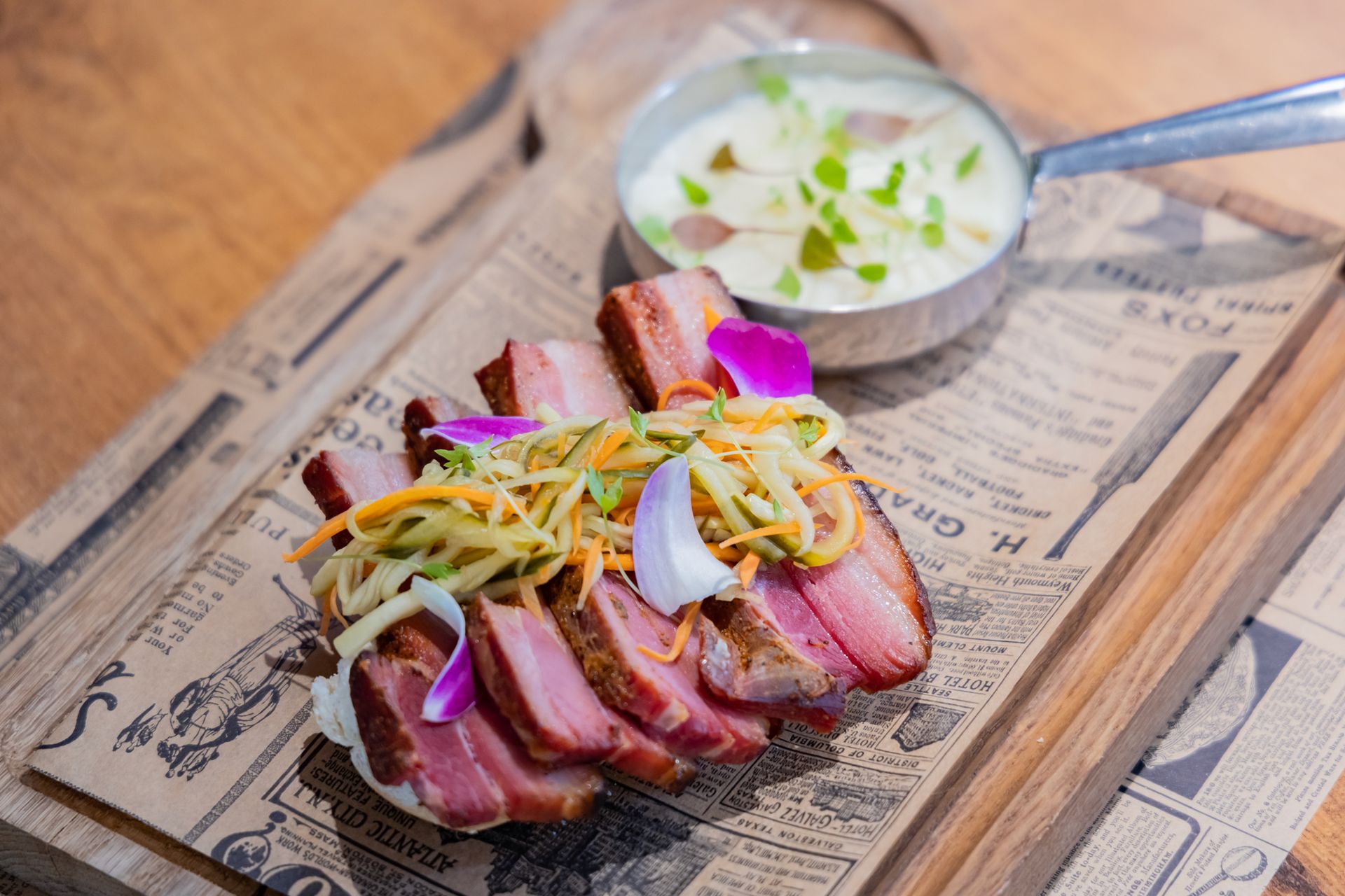 A close up of a plate of food on a wooden cutting board.
