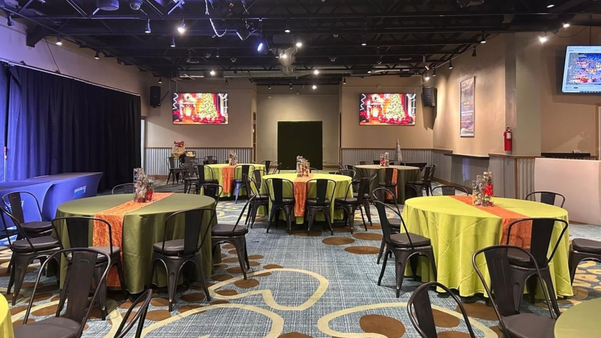 A large room with tables and chairs set up for a party.