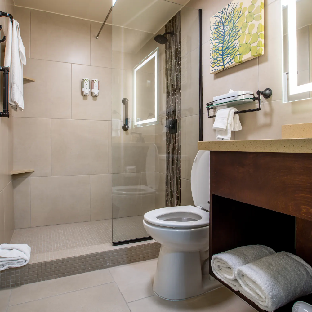 A bathroom with two sinks , a toilet , and a bathtub.