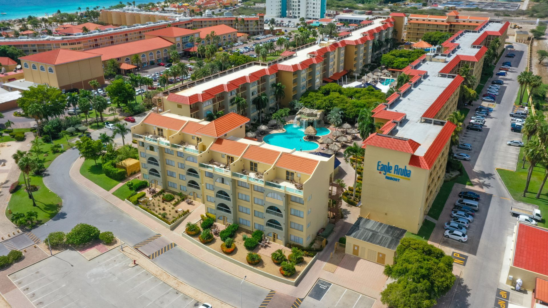 An aerial view of a beach with white sand and turquoise water.