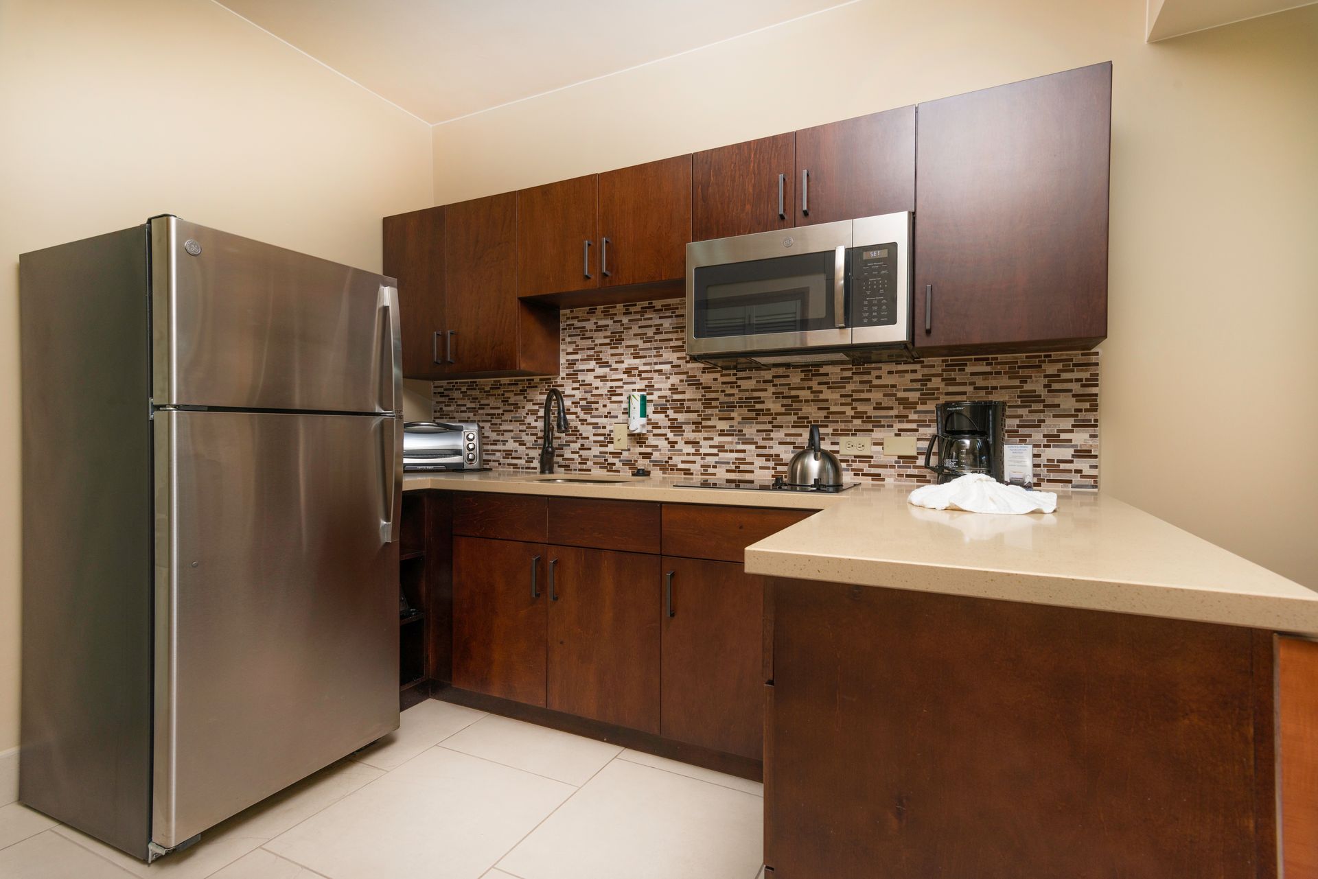 A kitchen with stainless steel appliances and wooden cabinets.