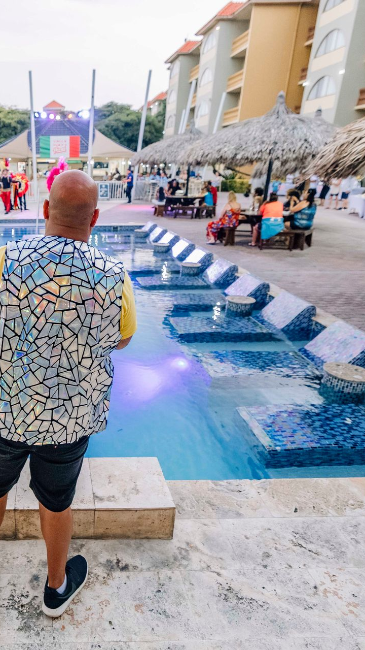 An aerial view of people swimming in a turquoise ocean.